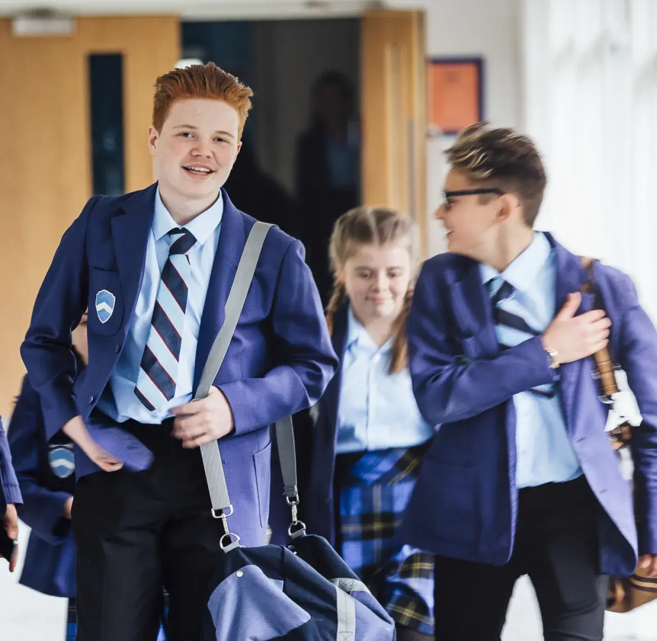 Students in uniform smiling after leaving classroom for NAPLAN assessment